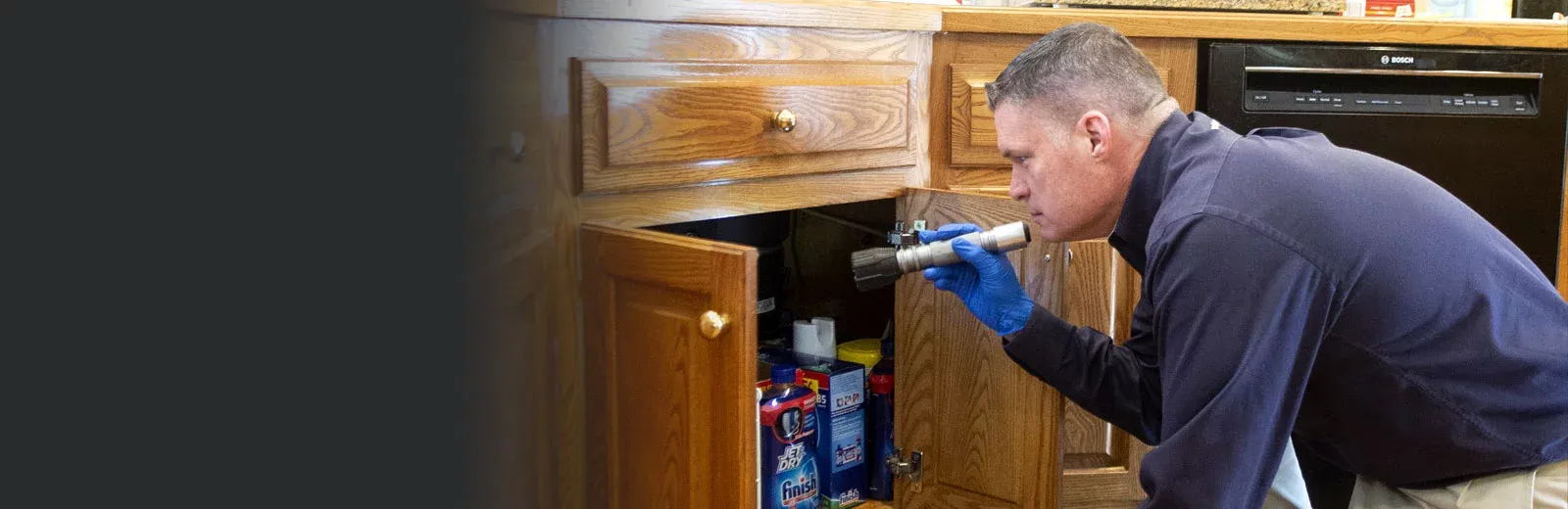 Service tech inspecting kitchen