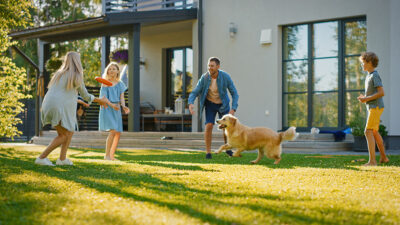 Family playing in backyard with dog